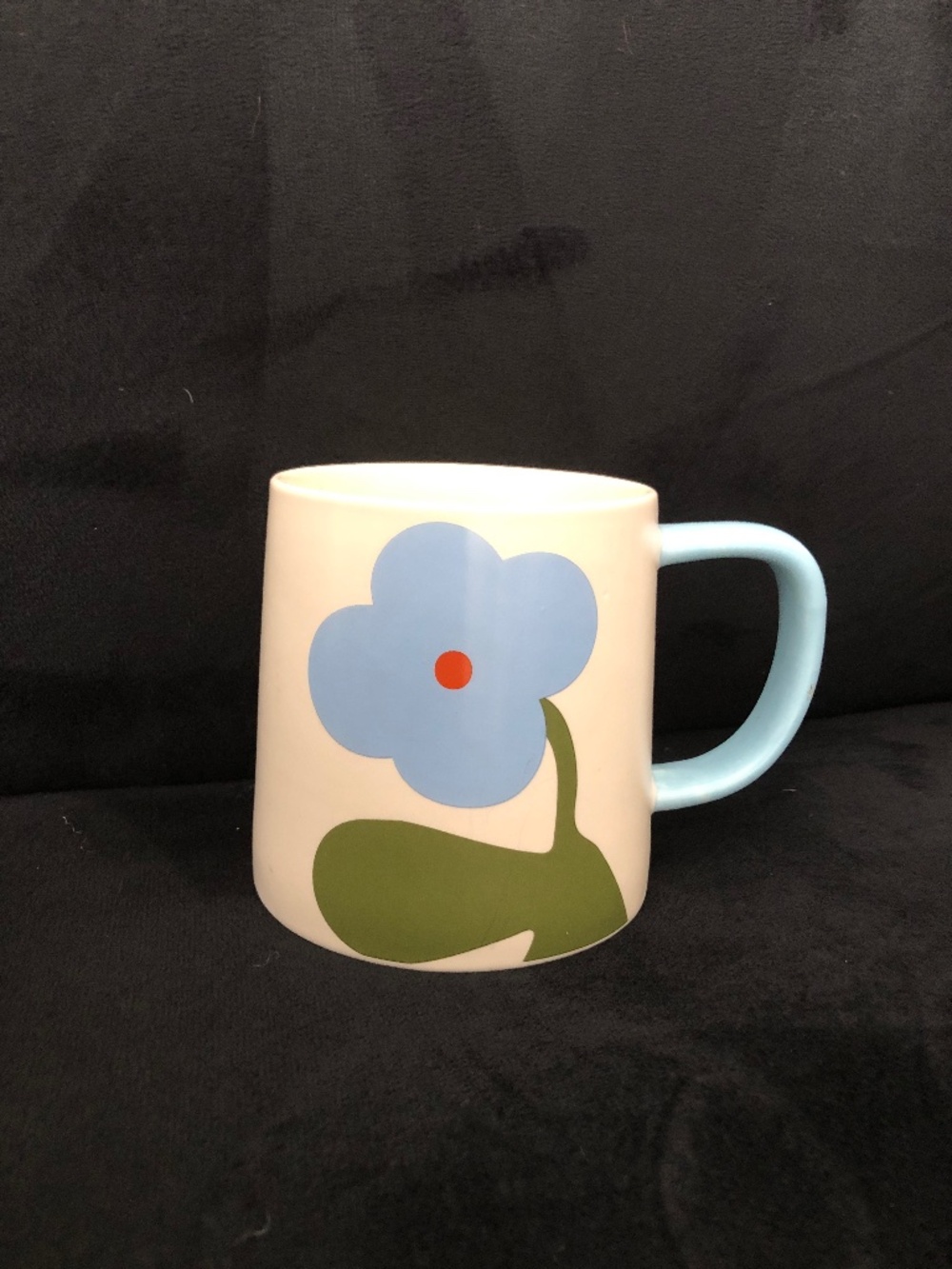 Retro-inspired blue flower with a vibrant orange center dot Mug from Indigo
